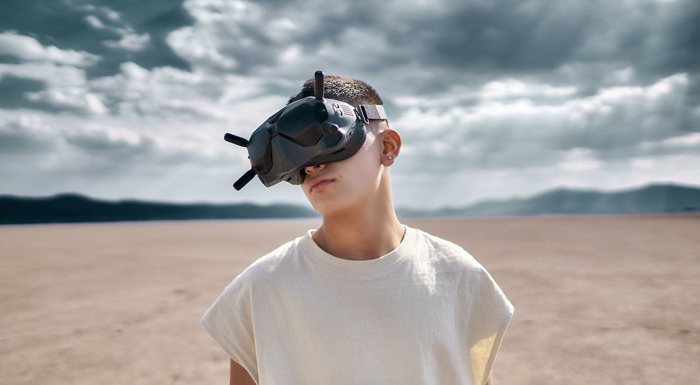 young man wearing a V.R headset, experiencing metaverse platforms